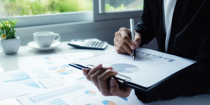 a person writing on a piece of paper