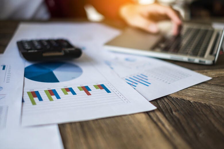 a close-up of a calculator and a paper on a table