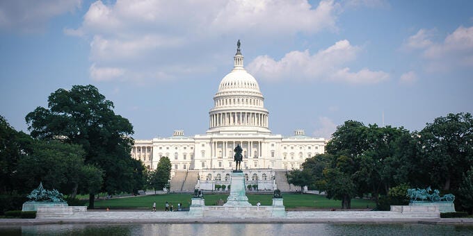 a white building with a dome and a fountain in front of it