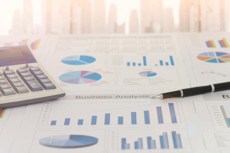 a close-up of a calculator and a pen on a paper
