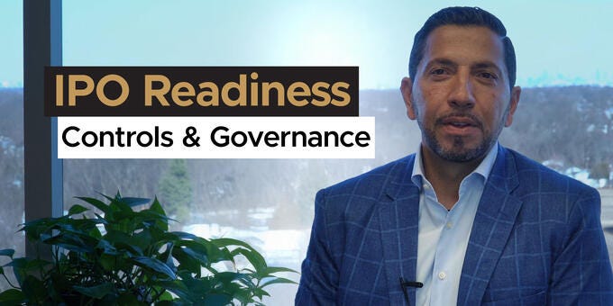 a man standing in front of a window with a plant and text above