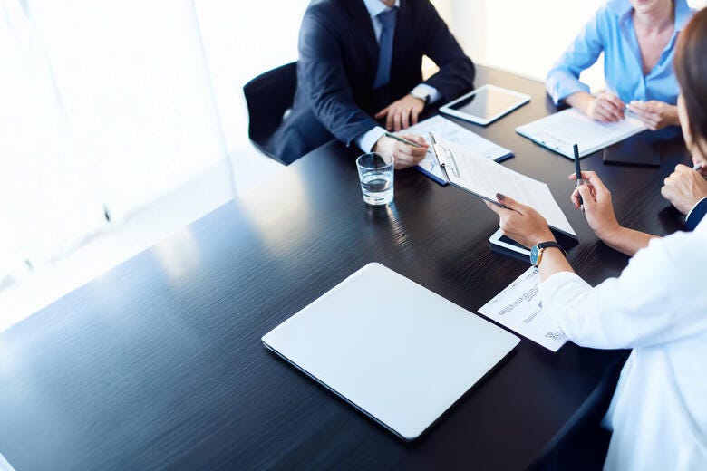 a group of people sitting around a table