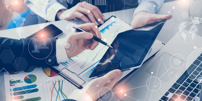 a person holding a pen and a tablet