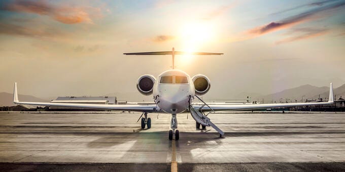 a couple of airplanes on a runway