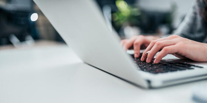 a person typing on a laptop