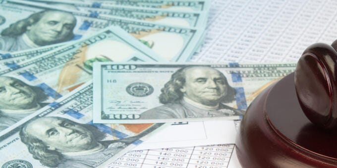 a gun lying on a pile of money