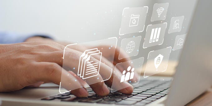 a close-up of hands typing on a laptop