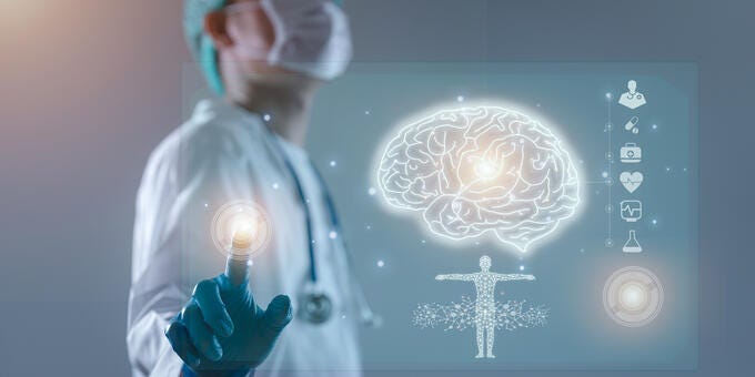 a person in a lab coat holding a light bulb