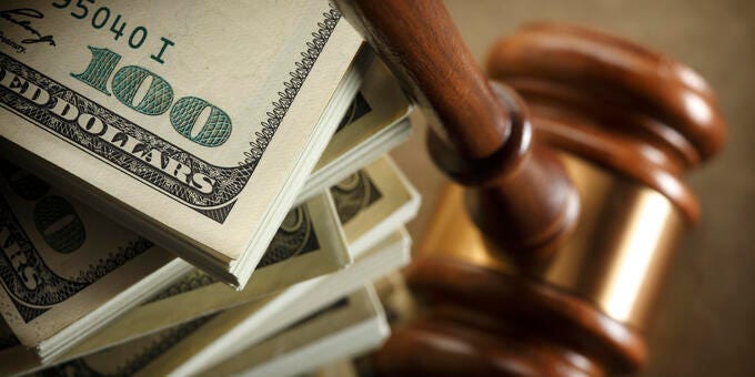 a gavel on top of a stack of paper money