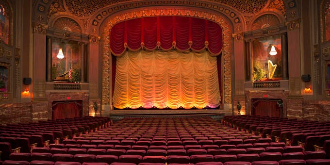 a large theater with red seats