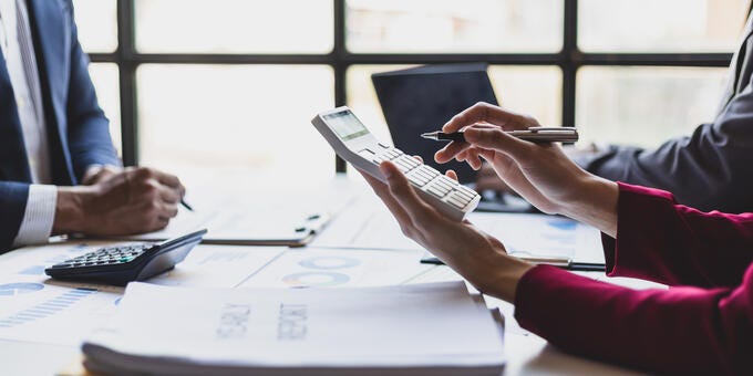 a few people working on a laptop