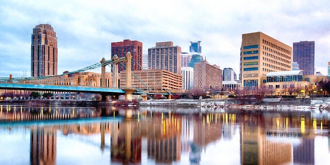 a city skyline with a bridge over a body of water