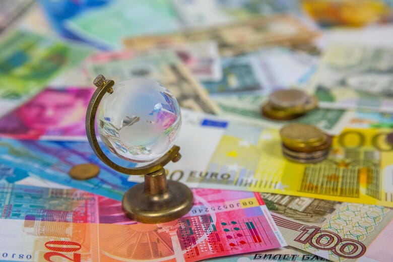 a gold trophy on a pile of money