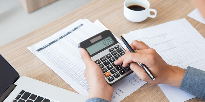 a person writing on a paper