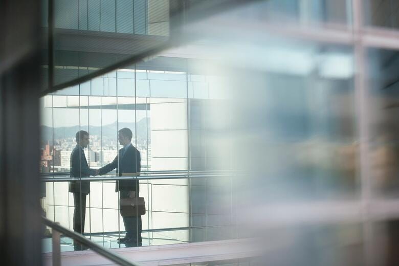 a few business people standing in a hallway
