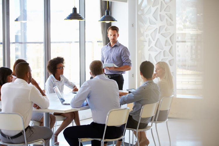 a group of people sitting around a table