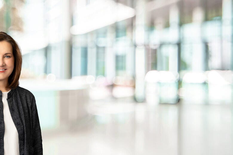 a woman smiling in a suit