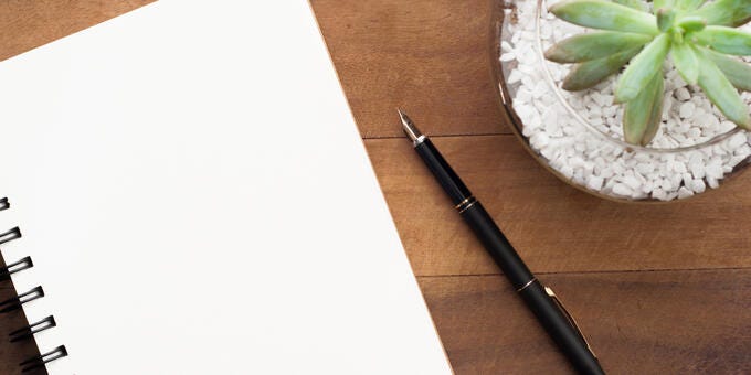 a pen and a paper on a table