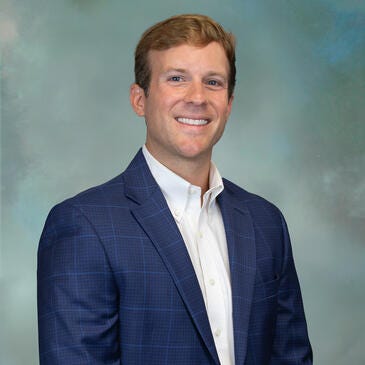 a man in a suit smiling