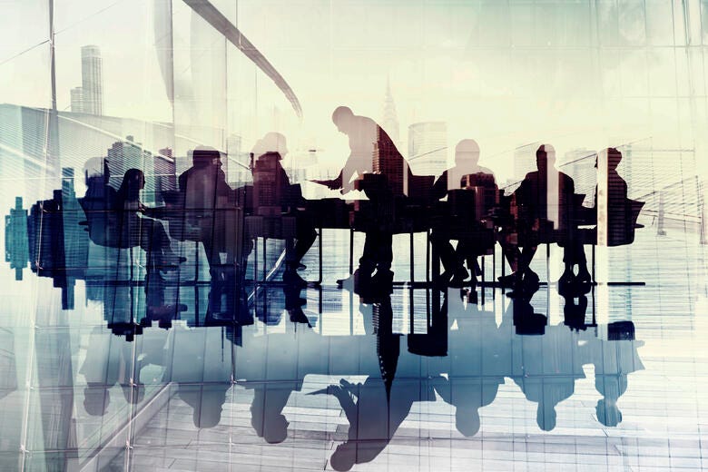 a group of people standing in front of a window