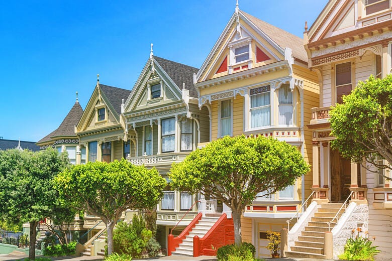 a large house with trees and stairs