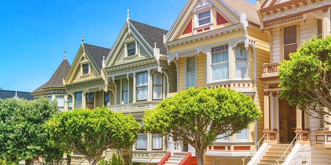 a large house with trees and stairs