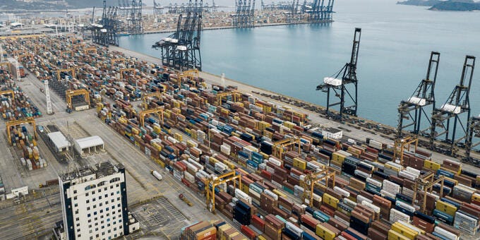 a port with many cranes and a large body of water