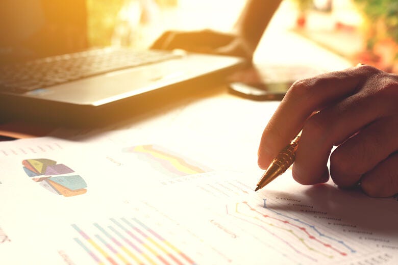 a hand holding a pen