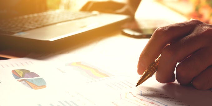 a hand holding a pen