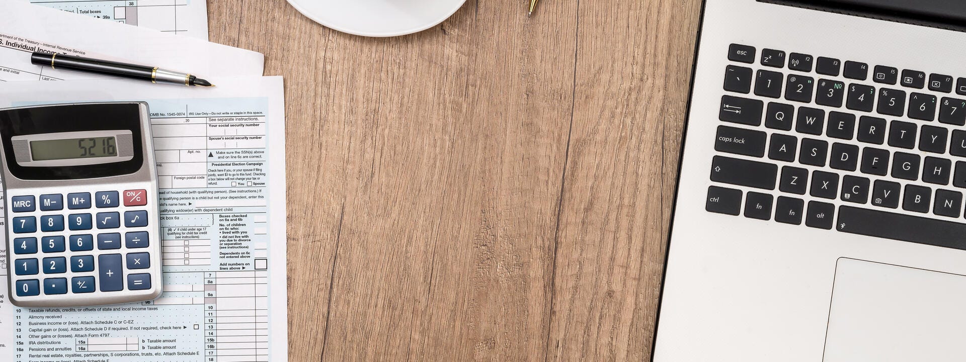 a desk with a laptop and a cup of coffee