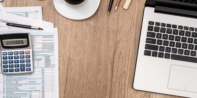 a desk with a laptop and a cup of coffee