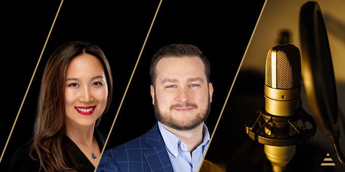 a man and woman standing next to each other with a gold chain