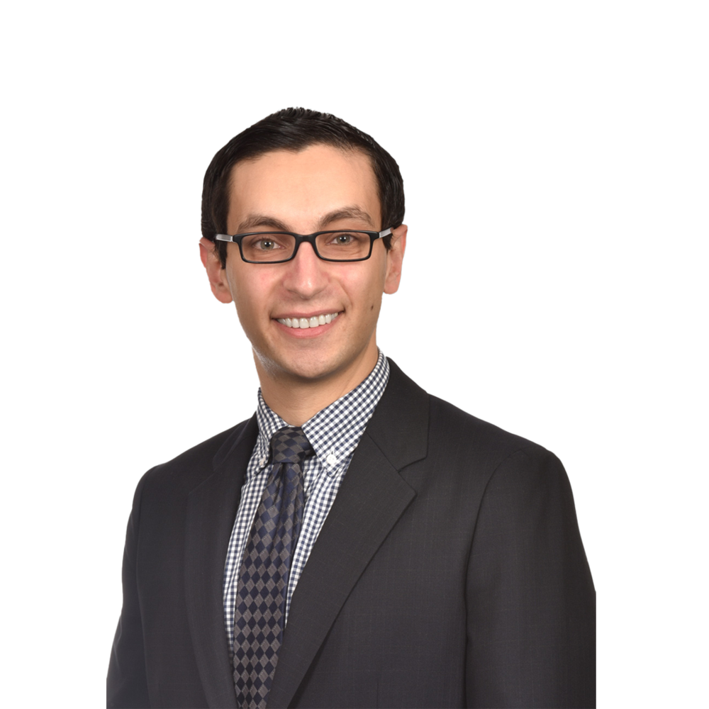 a man wearing glasses and a suit